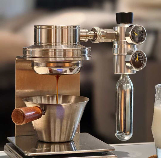 Top angled view of the Aerocync Mini portable espresso brewer resting on an acrylic base